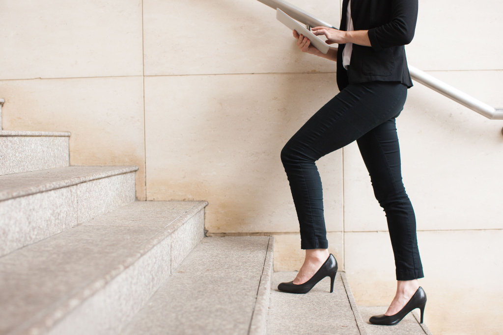 businesswoman-walking-upstairs-using-touchpad (1).jpg
